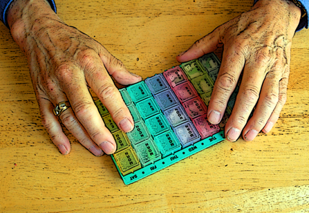 A pill case helps a senior citizen keep her pills straight. 