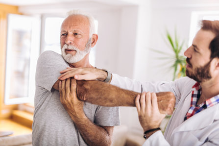 Chiropractor helping to handle pain.