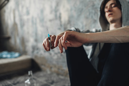Addict alone with a syringe