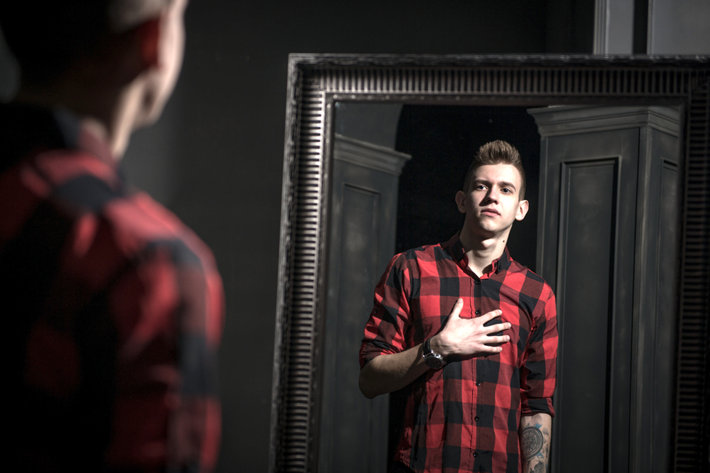 Young man in recovery standing at the mirror