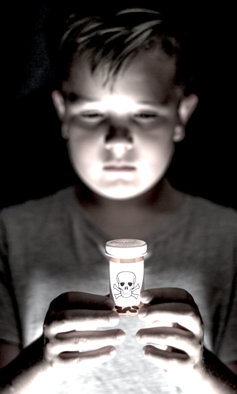 Little boy holding deadly prescription drugs.