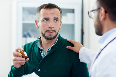 Man getting prescription pills from a doctor.