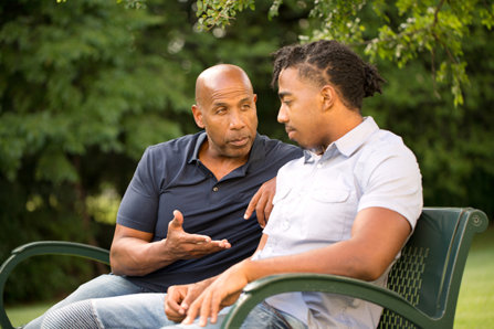 Father mentoring and giving advice to a younger man.