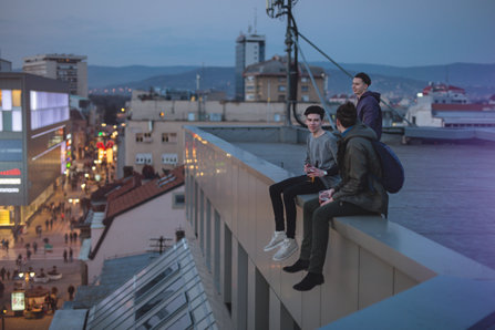 Young teenage hipsters spending their leisure time on a rooftop