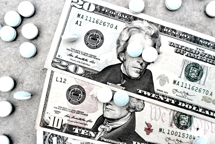 U.S. dollars covered with painkillers drugs.