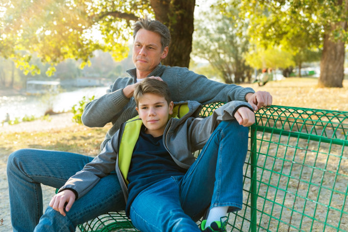 Father with son sitting on the bench